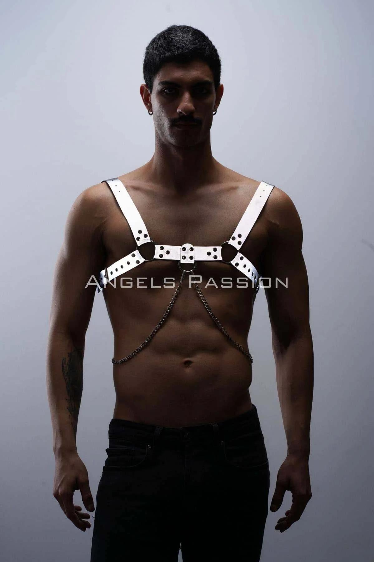 White reflective chest harness with black rivets and hanging silver chain worn by man on bare torso