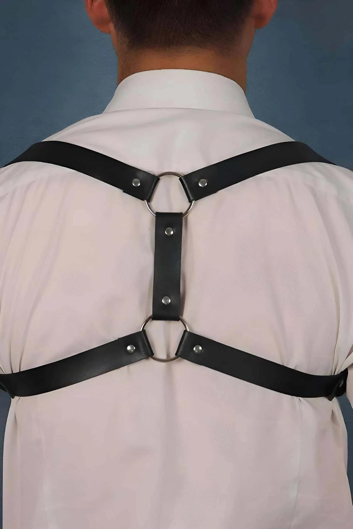 rear view of black adjustable back harness with rivet hardware and crossed straps