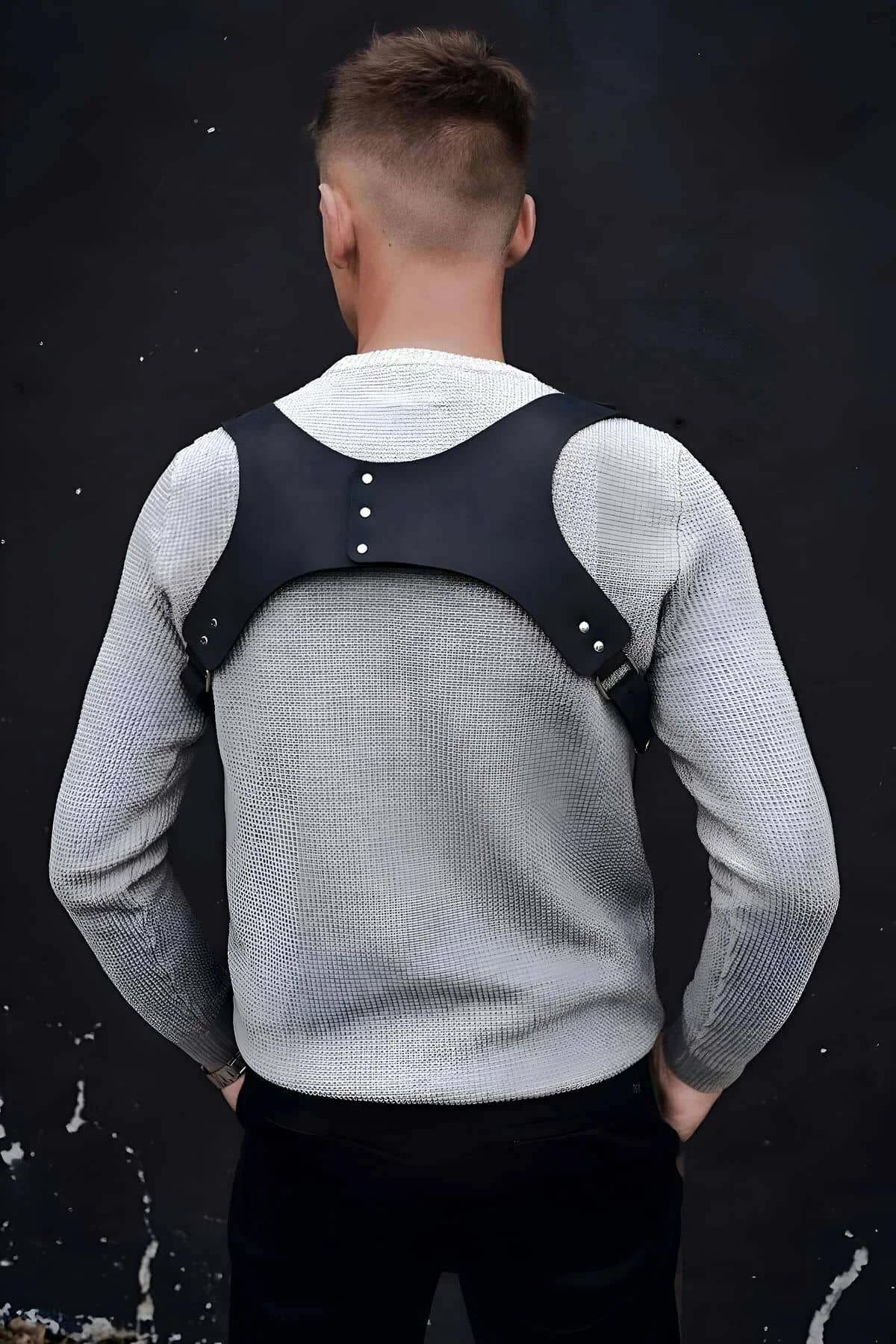 Mens black faux leather chest harness side angle showing strap width and fit over clothing