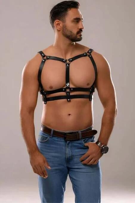 Close-up of silver snap rivet hardware on black faux leather harness strap junction