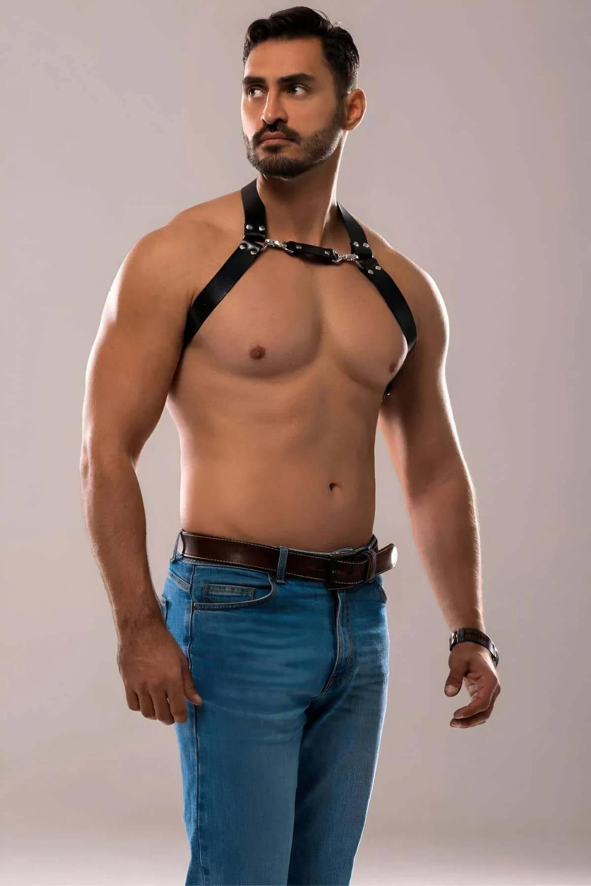side view of black faux leather chest harness showing strap width and shoulder adjustment