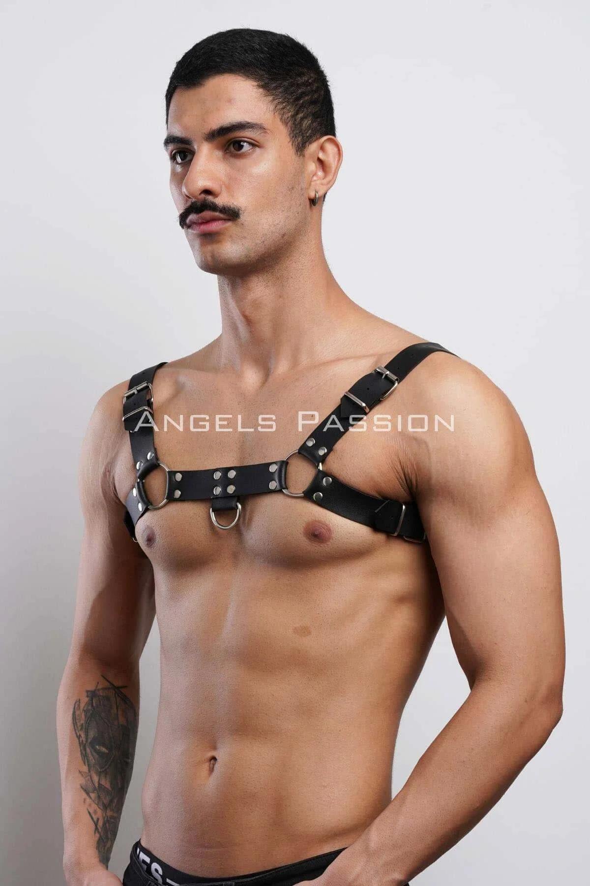 Close-up of silver O-ring and rivet detail on black faux leather chest band