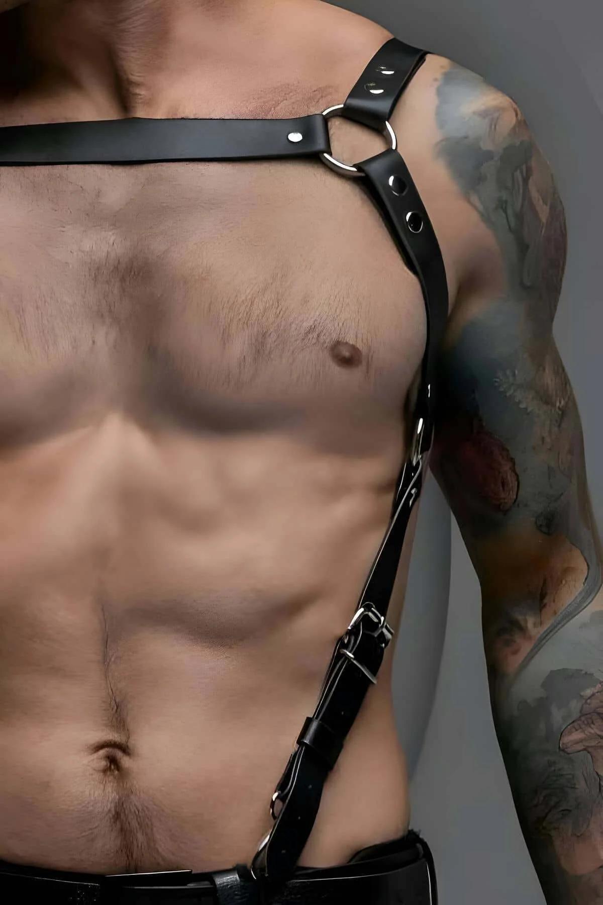 black faux leather chest harness with silver O-ring and asymmetric diagonal strap on male torso