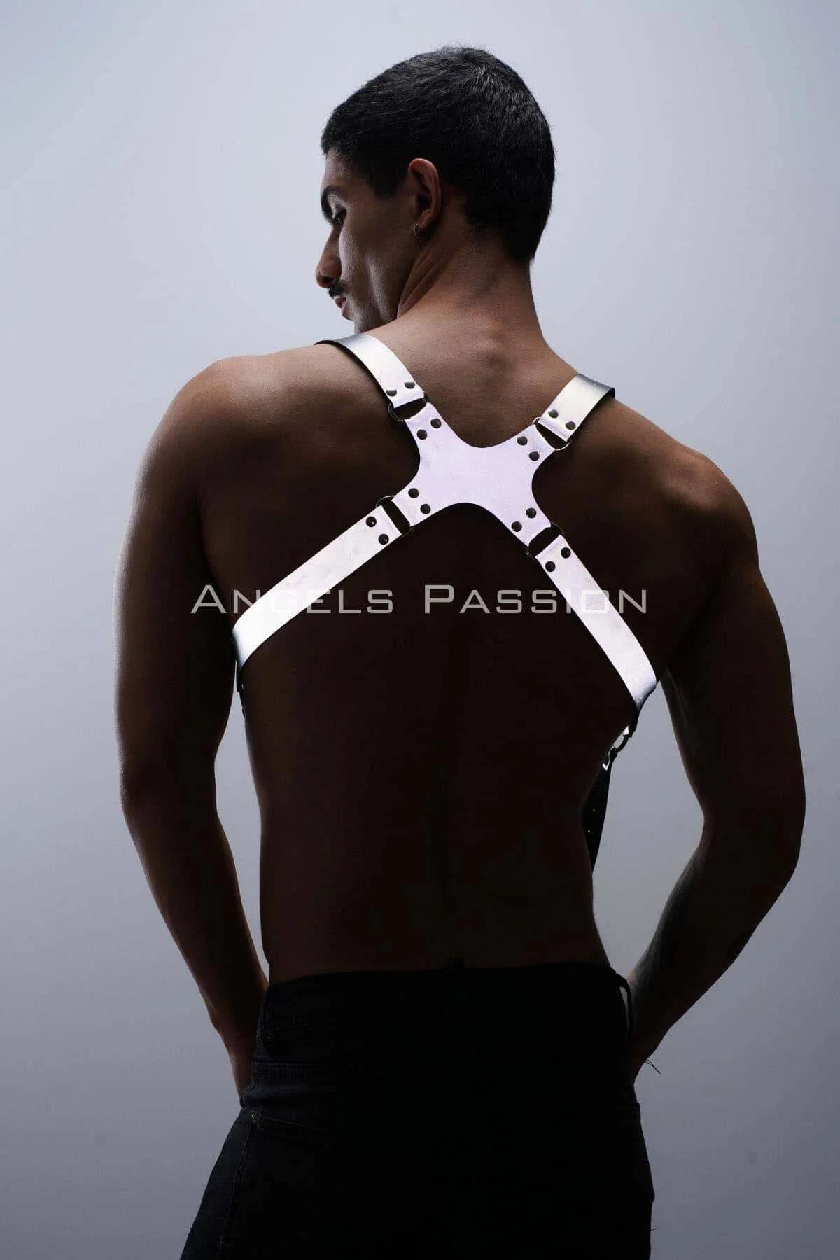 White adjustable body harness with metal clip fasteners at waistband styled with black trousers