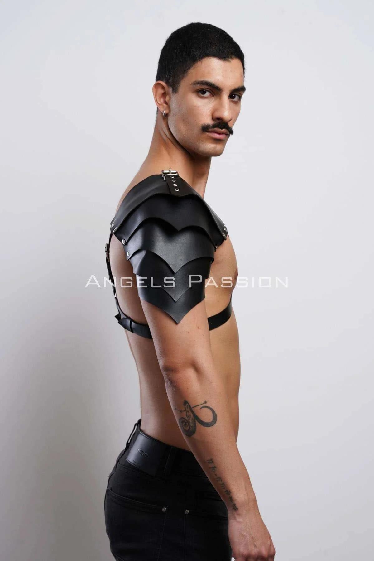 Detail of silver O-ring at sternum on black faux leather V-strap chest harness