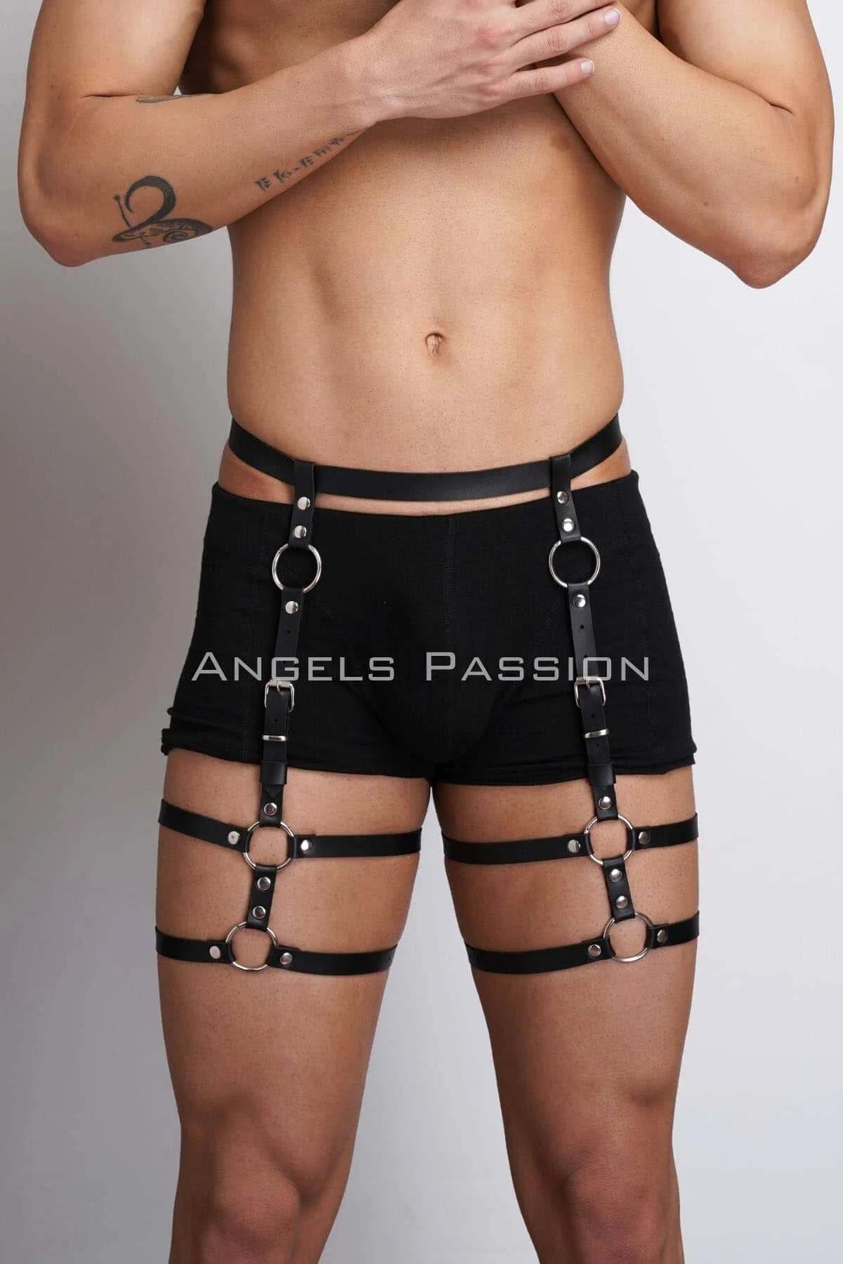 Black faux leather adjustable O-ring thigh harness with six silver rings and riveted straps worn over shorts
