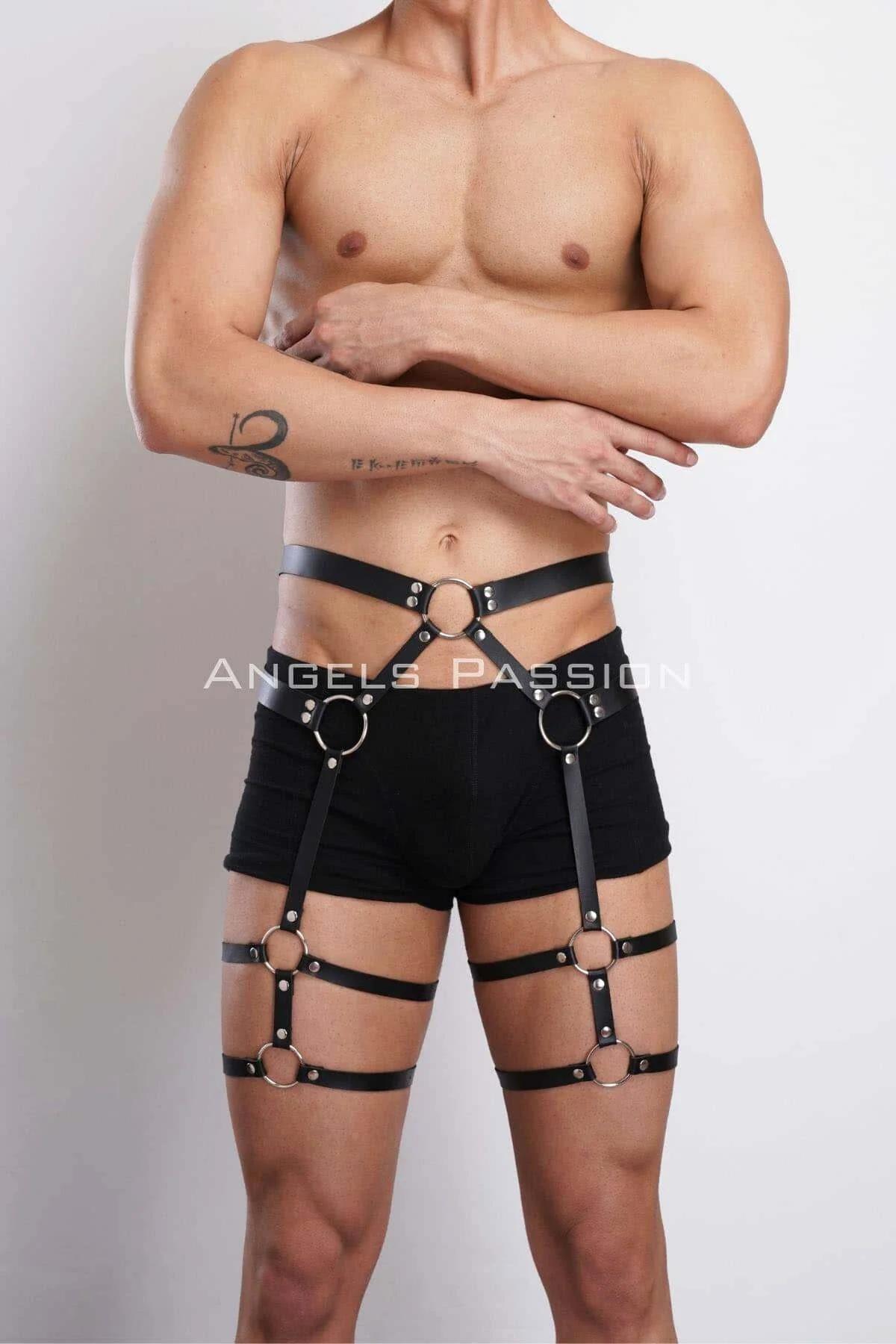 Close-up of silver O-ring junction on black faux leather thigh strap harness