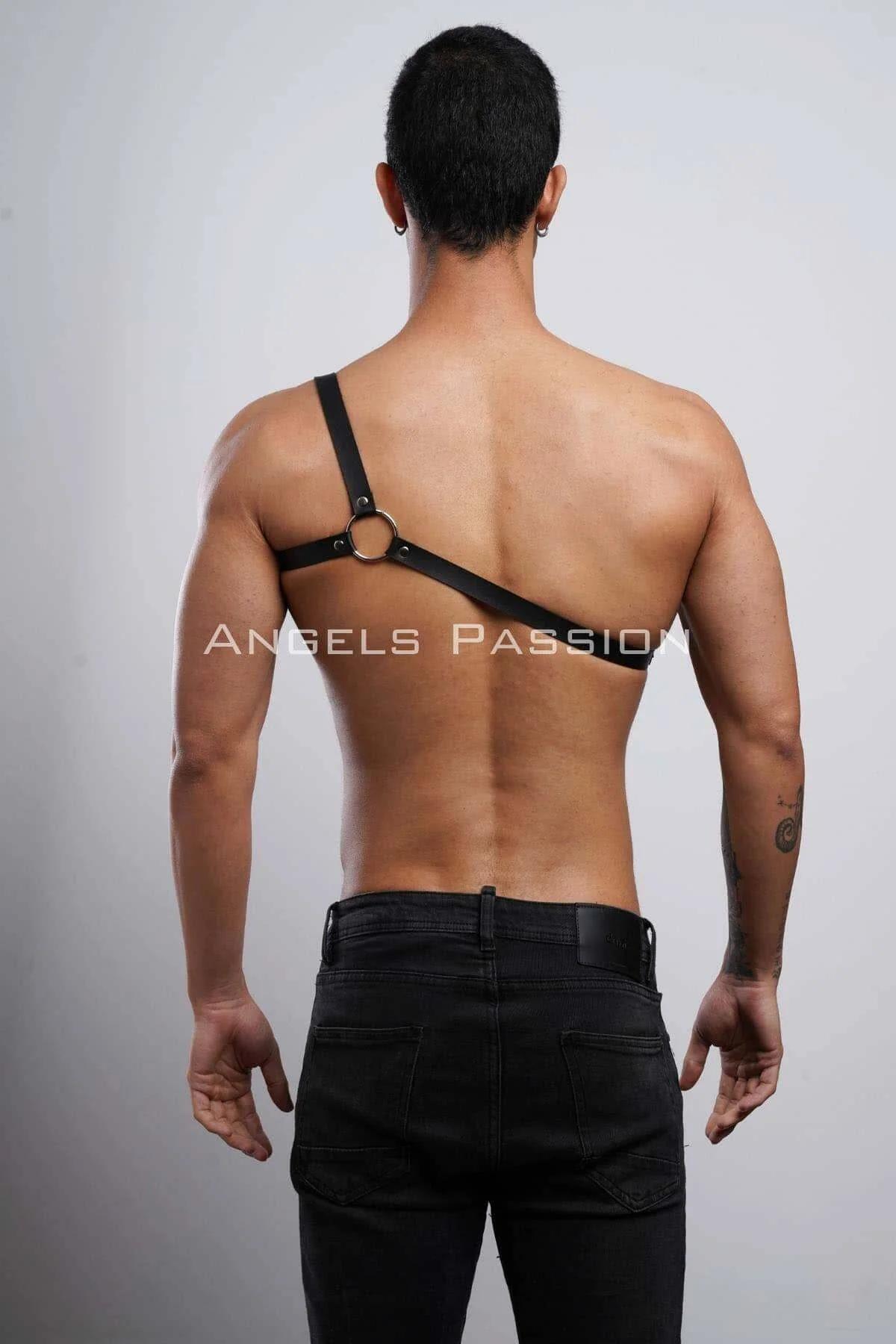 mens one-shoulder harness layered over black jeans festival streetwear styling