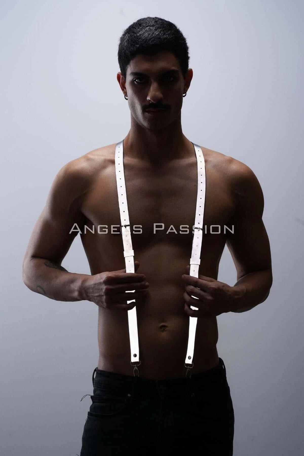 Silver metal clasps at lower ends of white reflective suspender harness straps