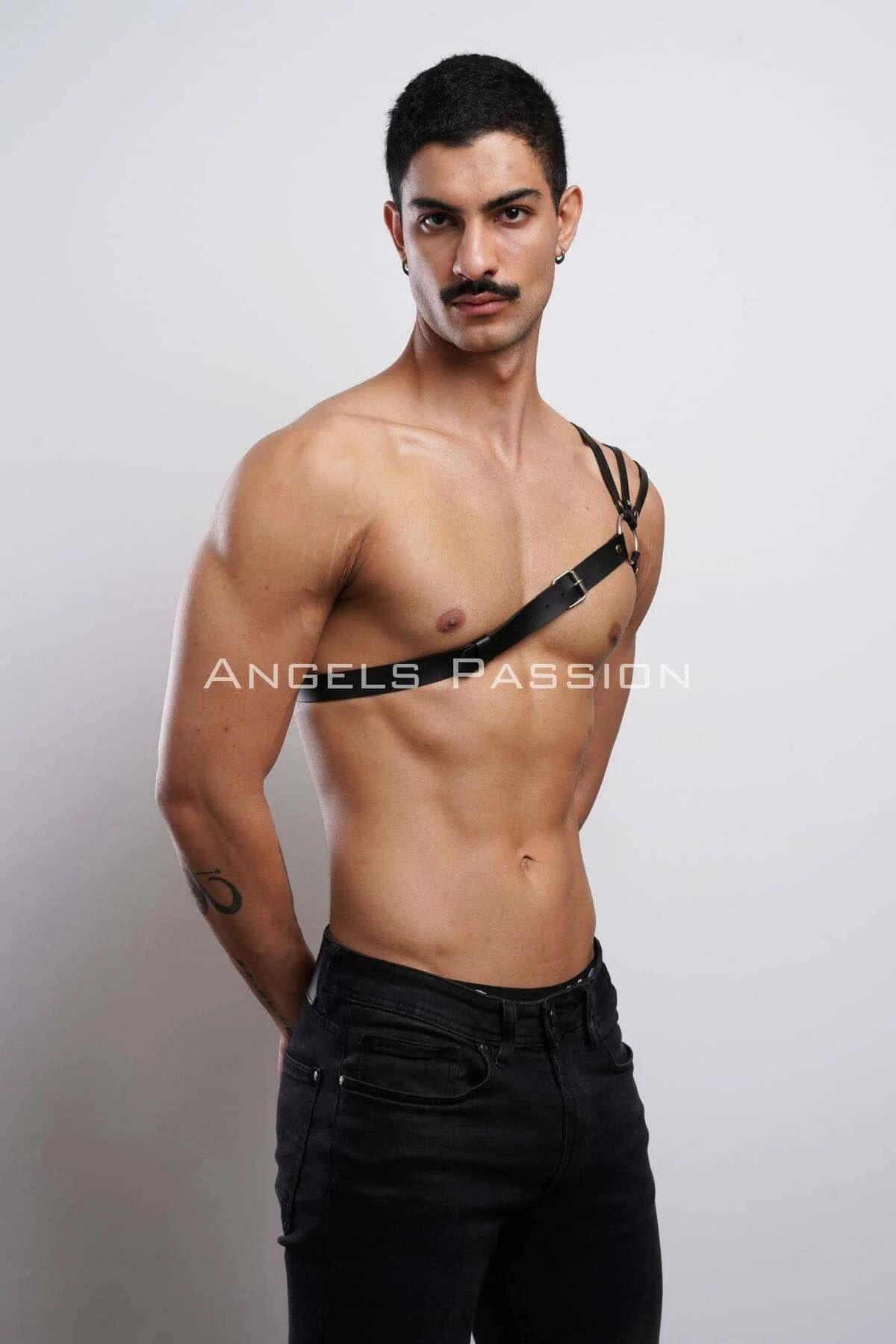 Close-up of gold-tone O-ring and matte black faux leather strap junction on chest harness