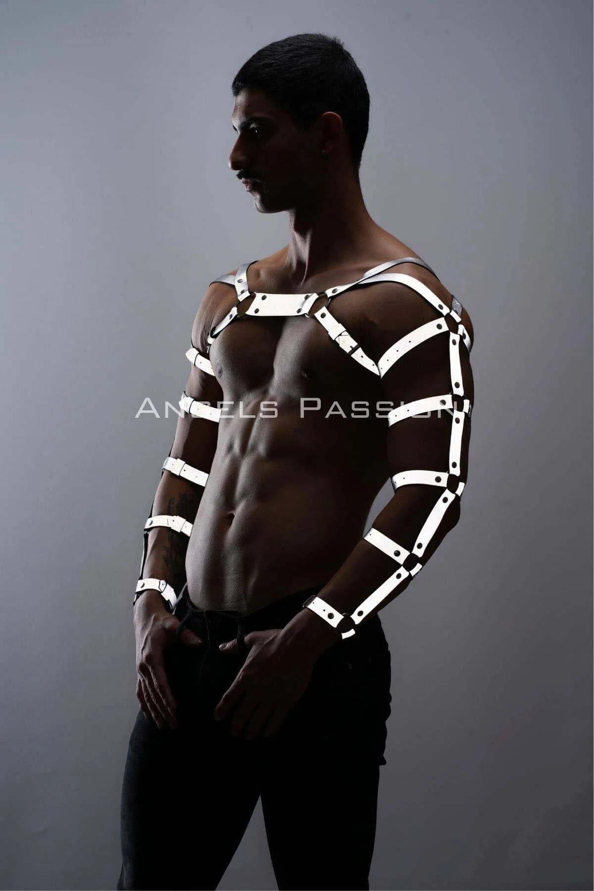 White arm and chest harness set worn with black jeans showing contrast between reflective straps and dark fabric