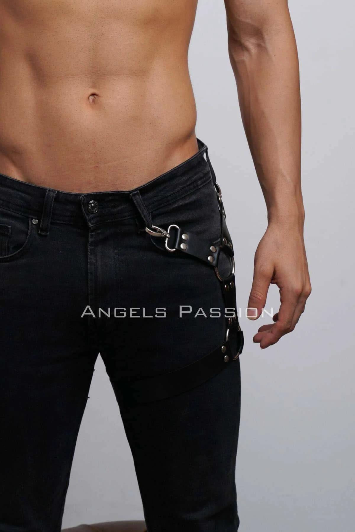 Close-up of silver O-rings and rivet snap studs on black PU leather leg harness strap