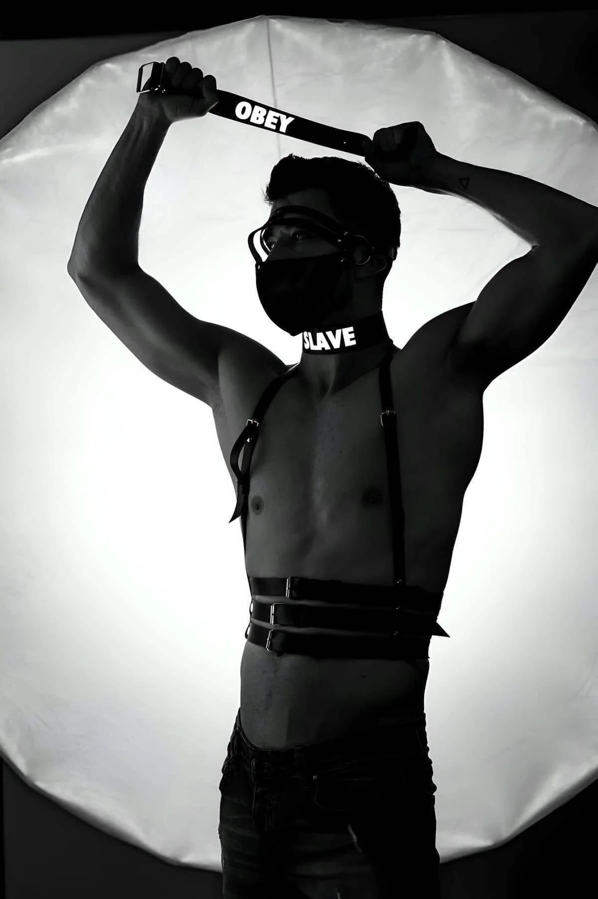 Matte black faux leather chest harness straps with silver zinc-alloy buckles close-up detail
