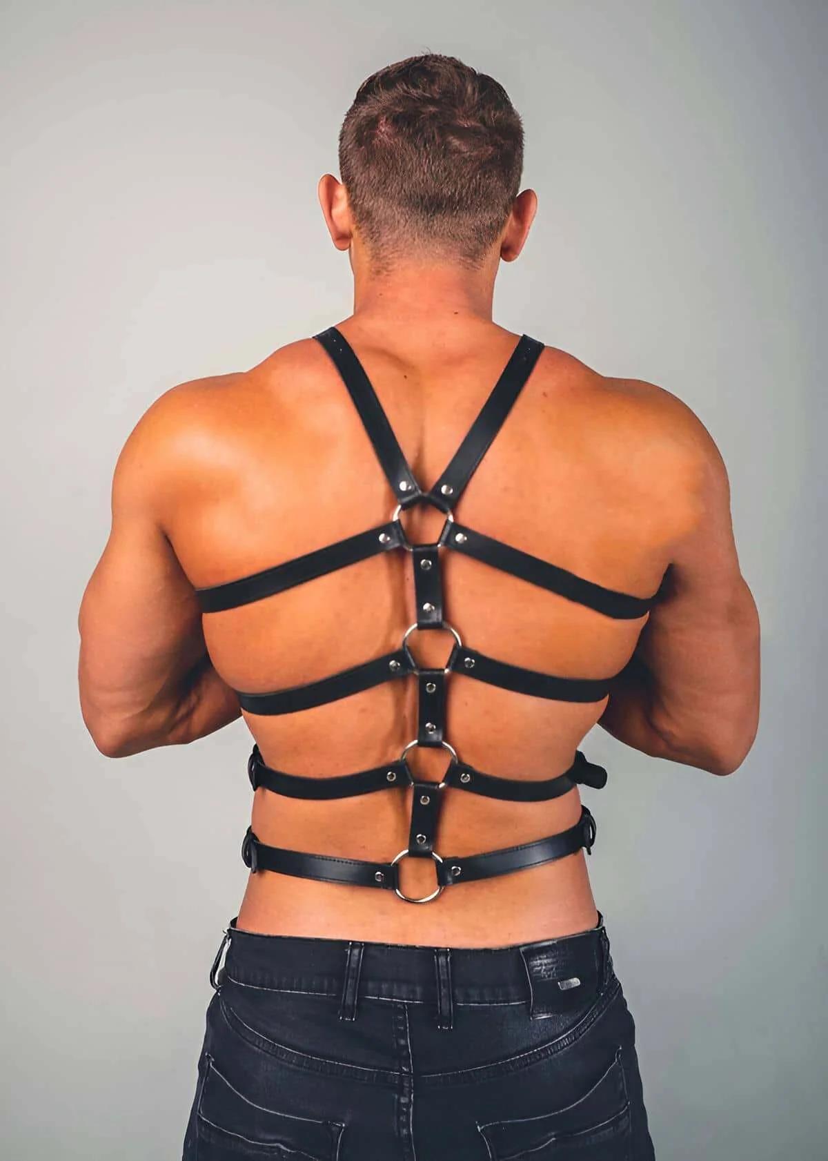 Black PU faux leather chest harness four-band cage detail with silver single-pin buckles close-up