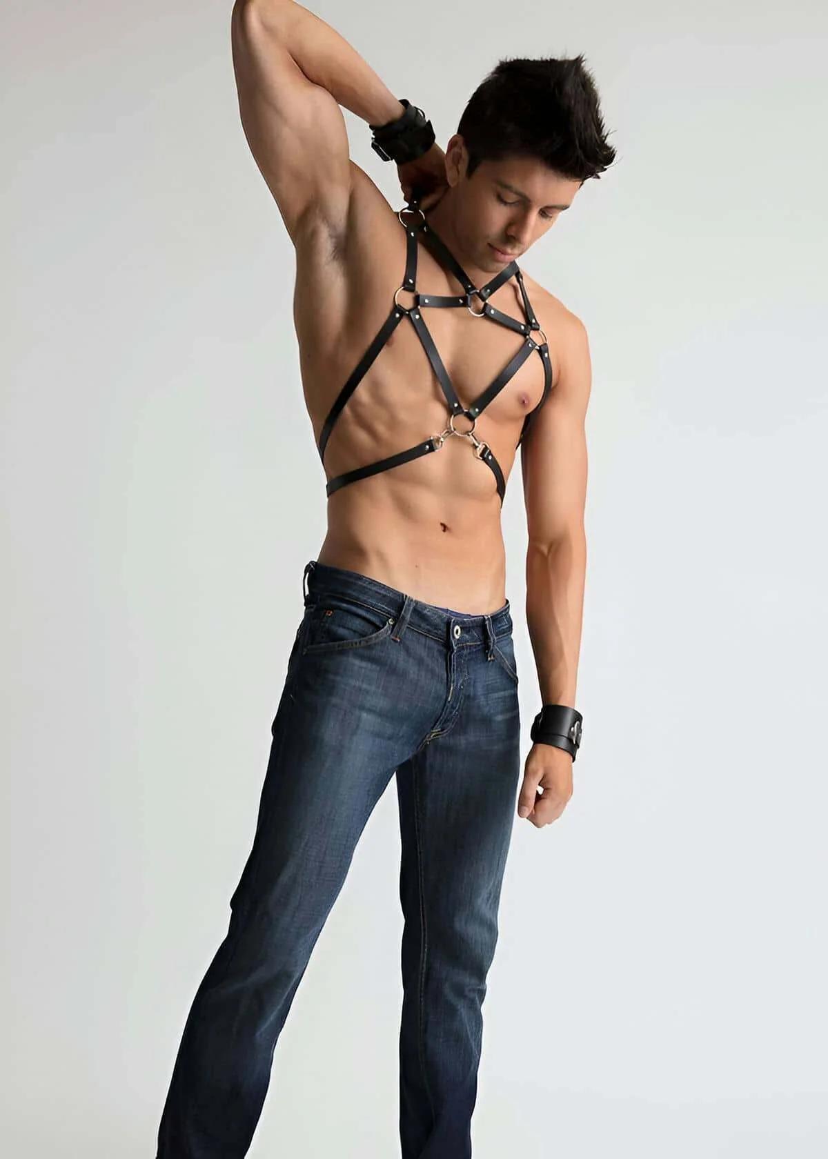 close-up of gold-tone O-ring at strap intersection on black faux leather chest harness