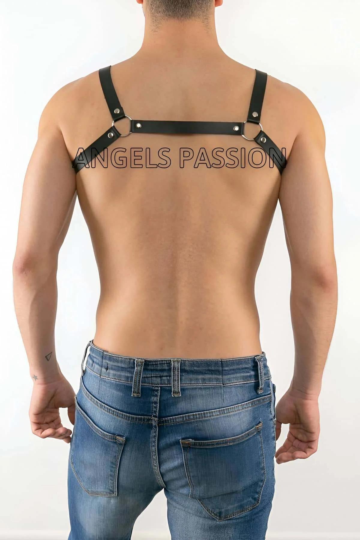 silver O-ring hardware detail on black mens chest harness strap connection point