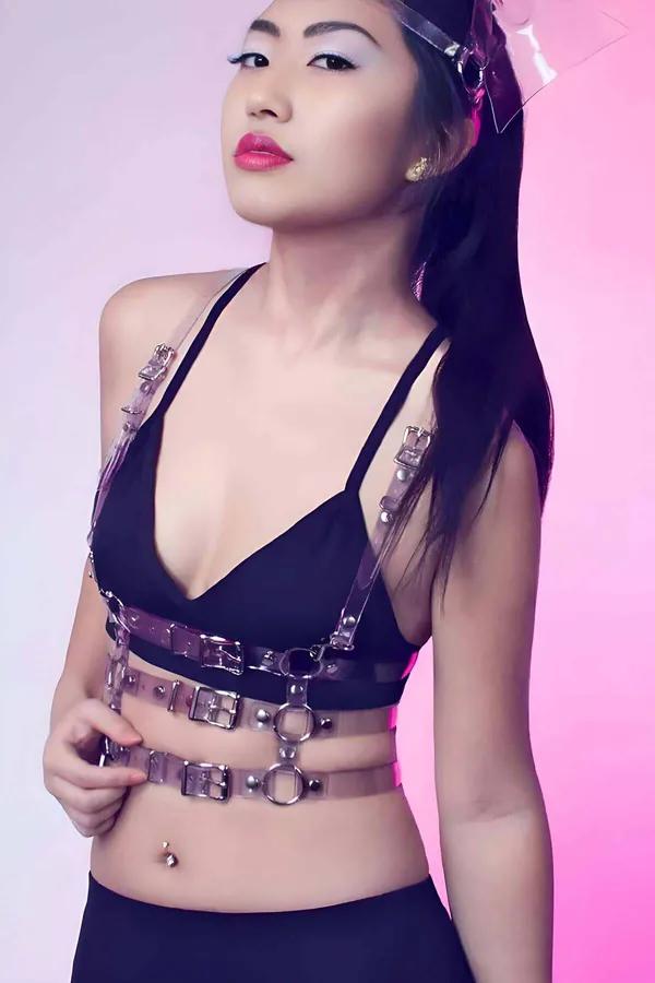 transparent clear PVC chest harness with three horizontal bands silver O-ring hardware and buckle closures worn over black br