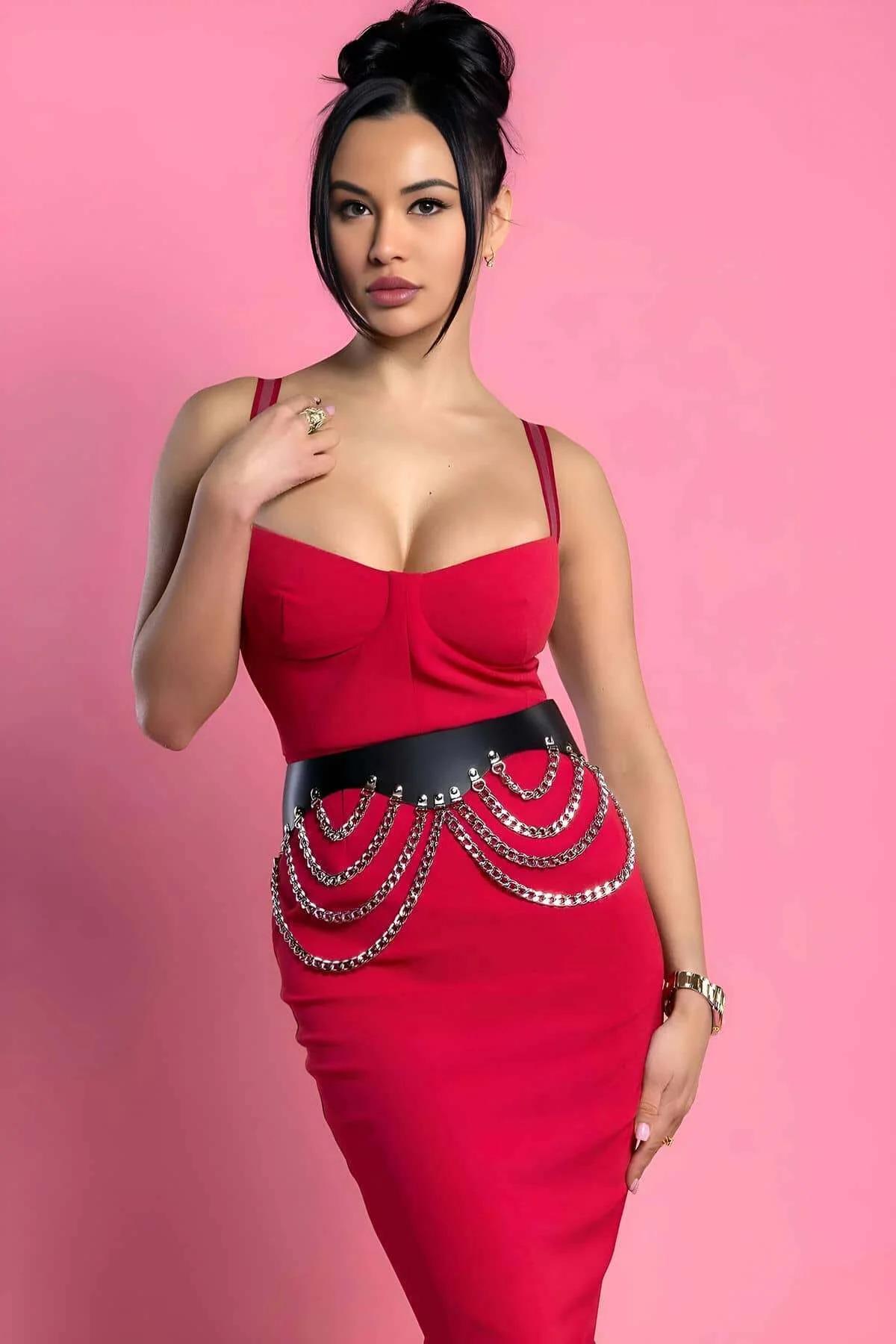 Black faux leather studded belt with four rows of cascading silver chains draped across the front waistband