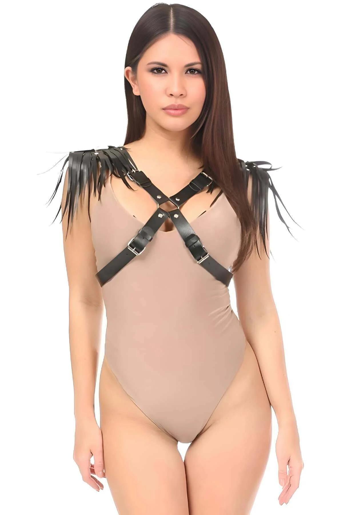 Black faux leather shoulder harness with fringe tassels and X-cross chest straps, silver buckles, worn over nude bodysuit