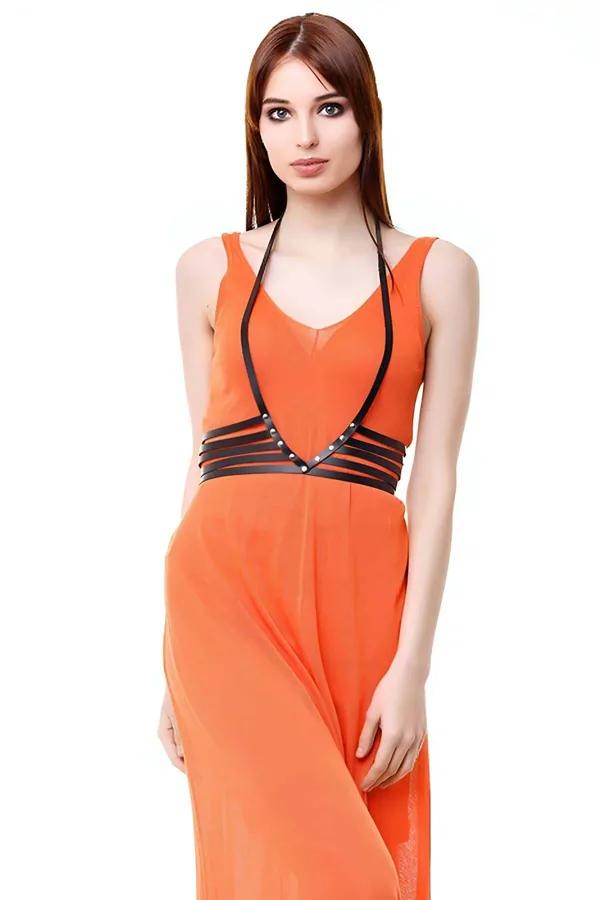 Black faux leather V-neck body harness with silver studs and four horizontal waist straps worn over orange dress