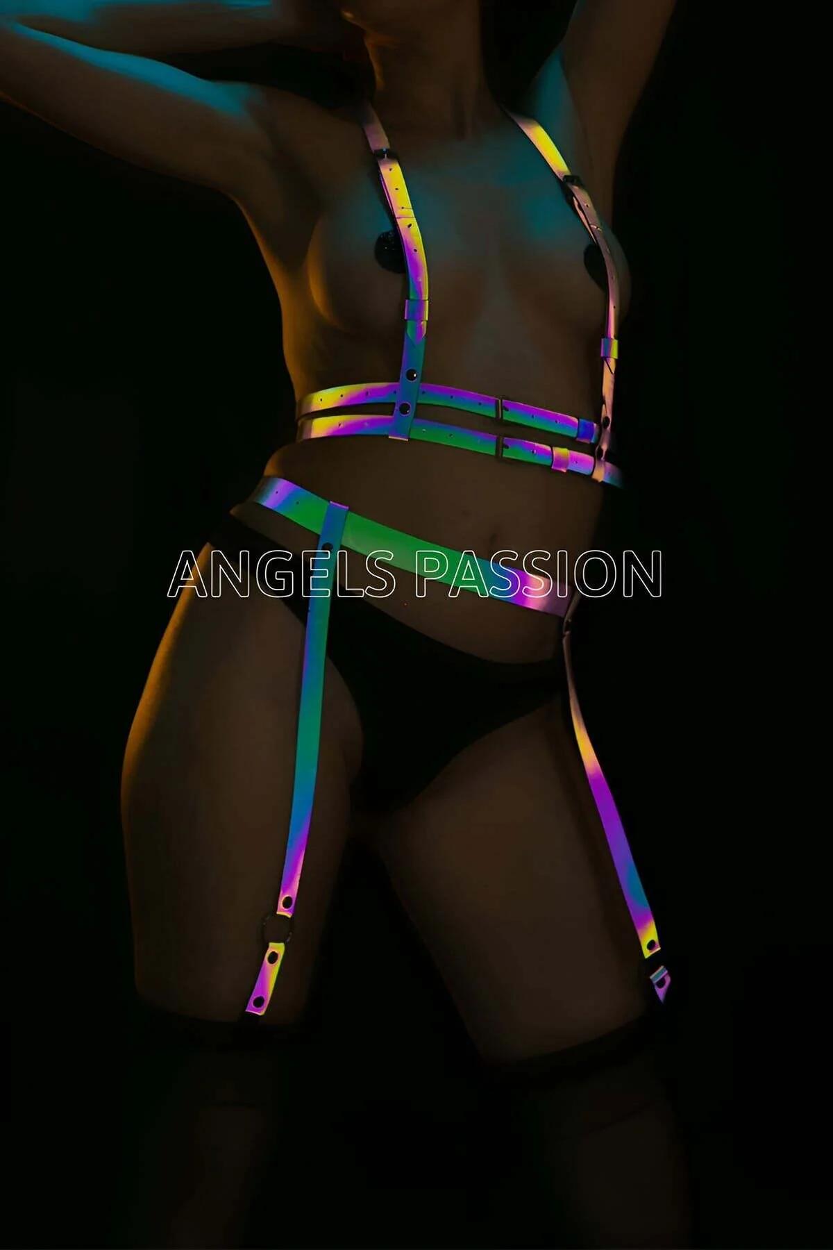 Rainbow reflective body harness and garter set with iridescent holographic straps and silver buckles on dark background