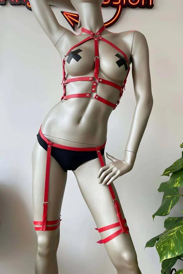 Red faux leather body harness with multi-strap chest cage, hip belt, and double-wrap thigh garter straps with silver O-ring h