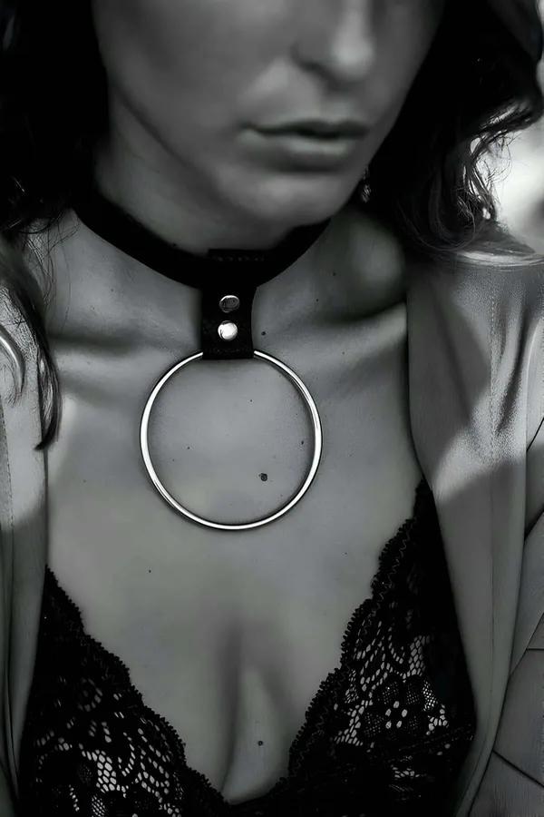 black vegan leather choker necklace with large silver O-ring pendant worn at collarbone