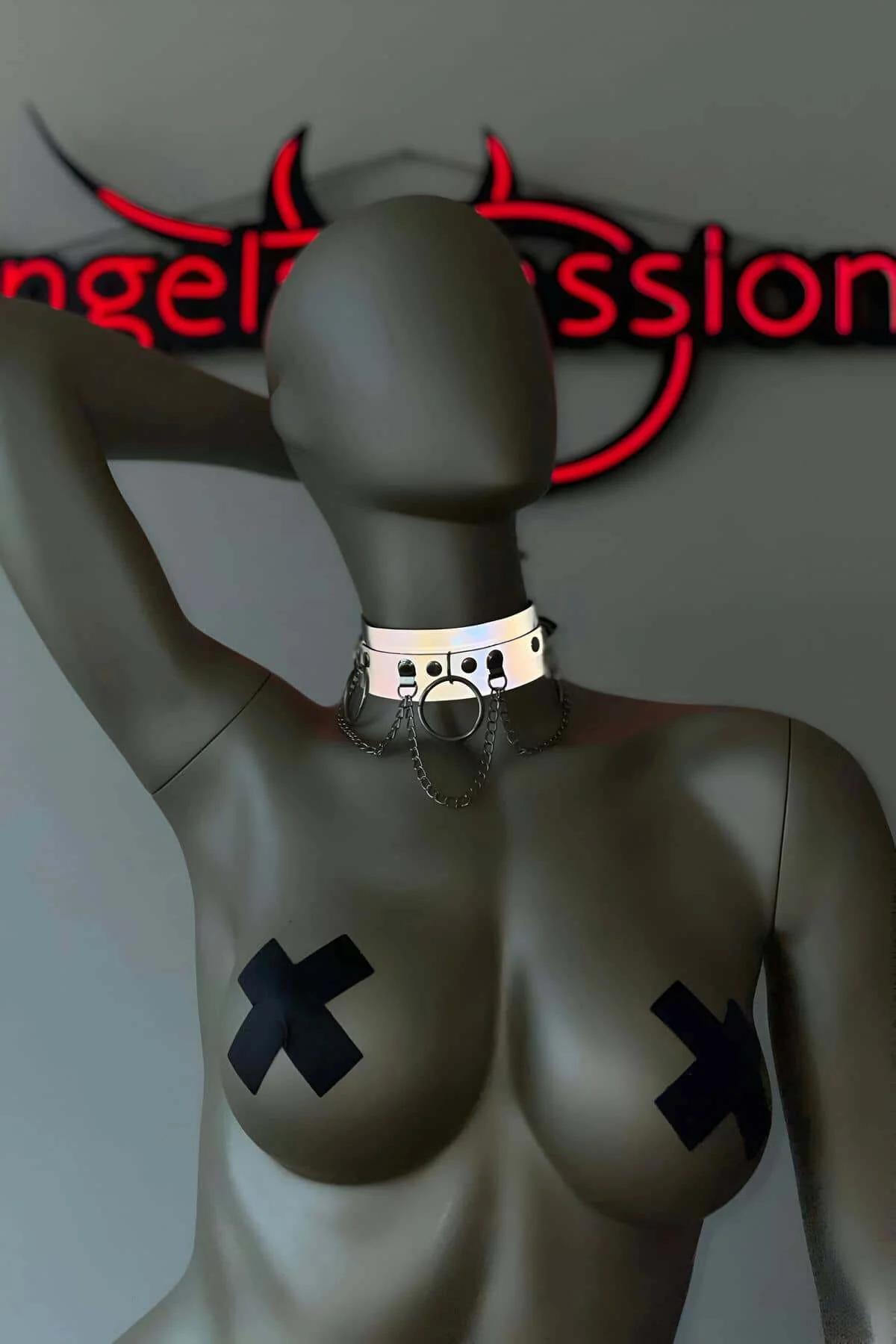 White reflective PVC choker collar with central gunmetal O-ring and dual silver chain drapes on mannequin