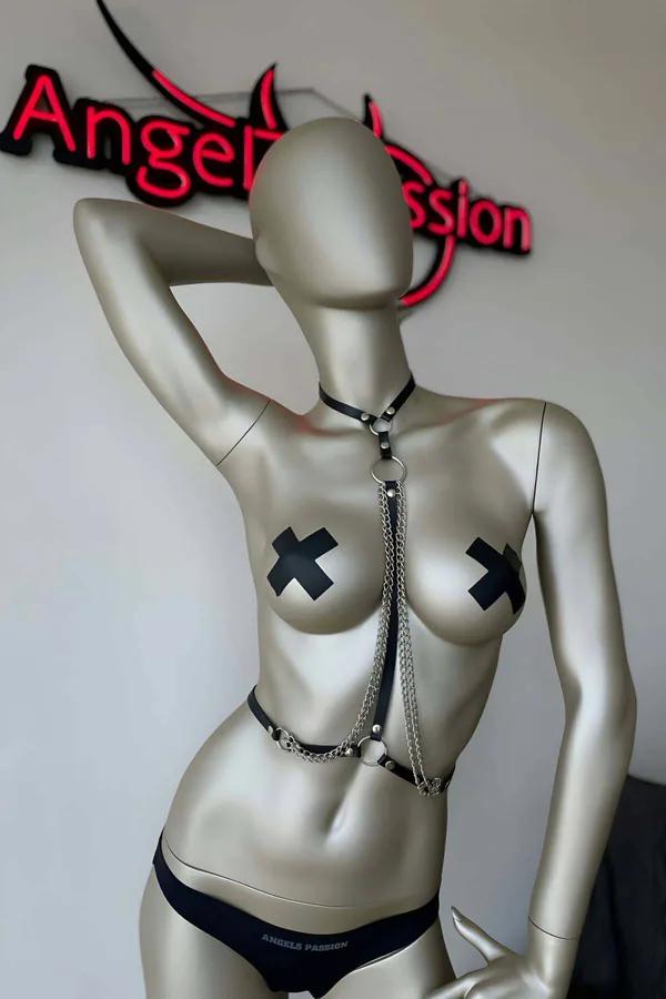 Black faux leather chest harness with silver O-rings and three layered chains connecting choker collar to waist band
