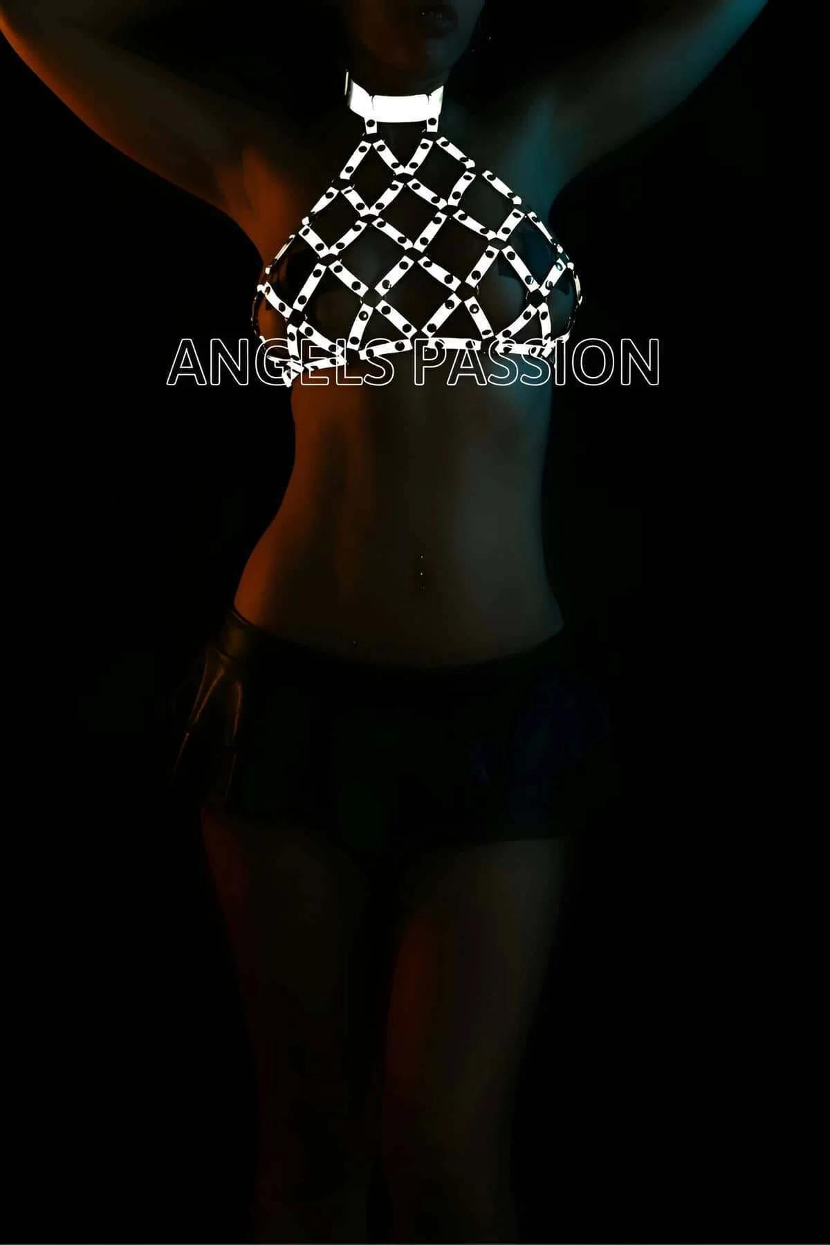Silver reflective chainmail halter top harness with diamond-lattice metal links glowing under dark club lighting