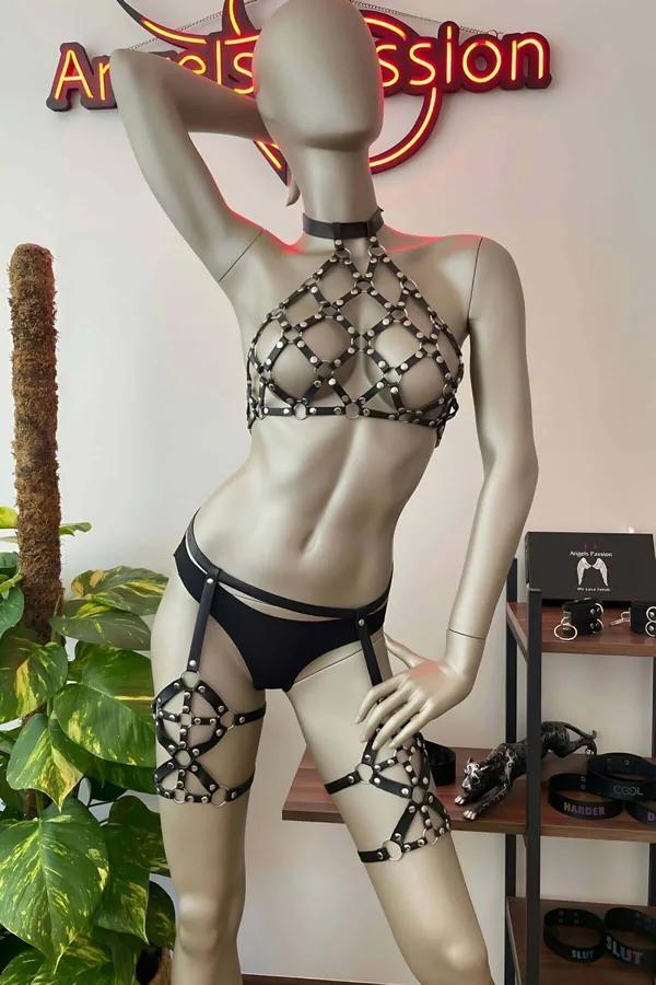 Black faux leather studded cage halter harness with silver dome rivets and matching thigh garter bands on mannequin