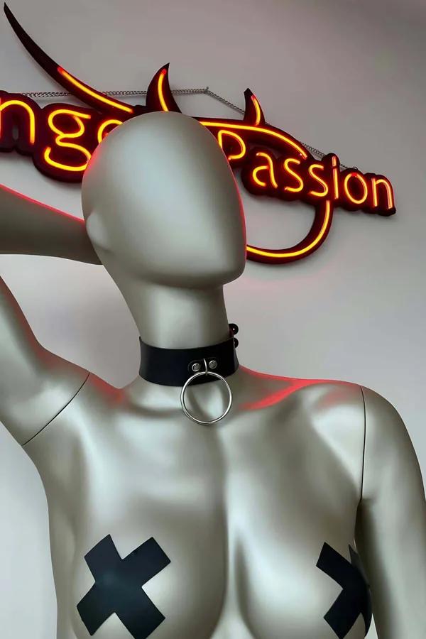 Black faux leather O-ring choker necklace with silver buckle closure on mannequin neck