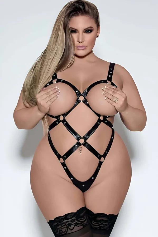 Black faux leather full body cage harness with silver dome studs and three O-rings on plus-size model