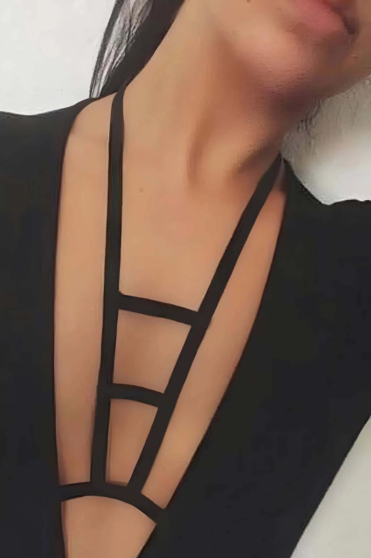 black elastic strappy plunge chest harness with geometric ladder panel framing deep neckline