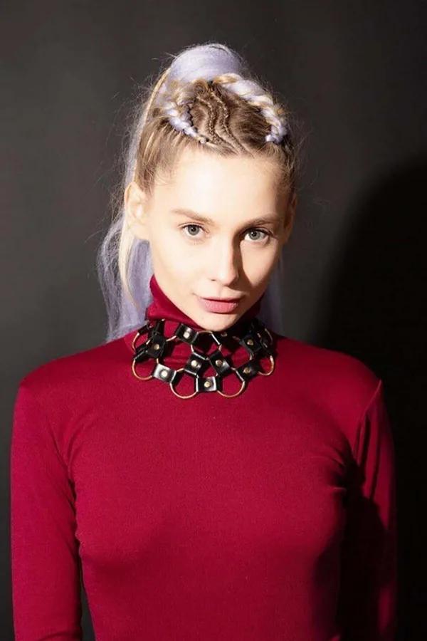 Black faux leather hexagonal chain choker with gold-tone metal rings worn as structured collar neckpiece