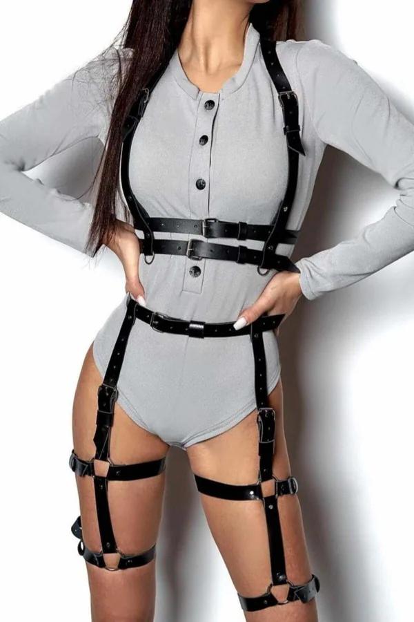black faux leather full body harness with layered chest straps double waist band and dual thigh garter rings worn over grey b