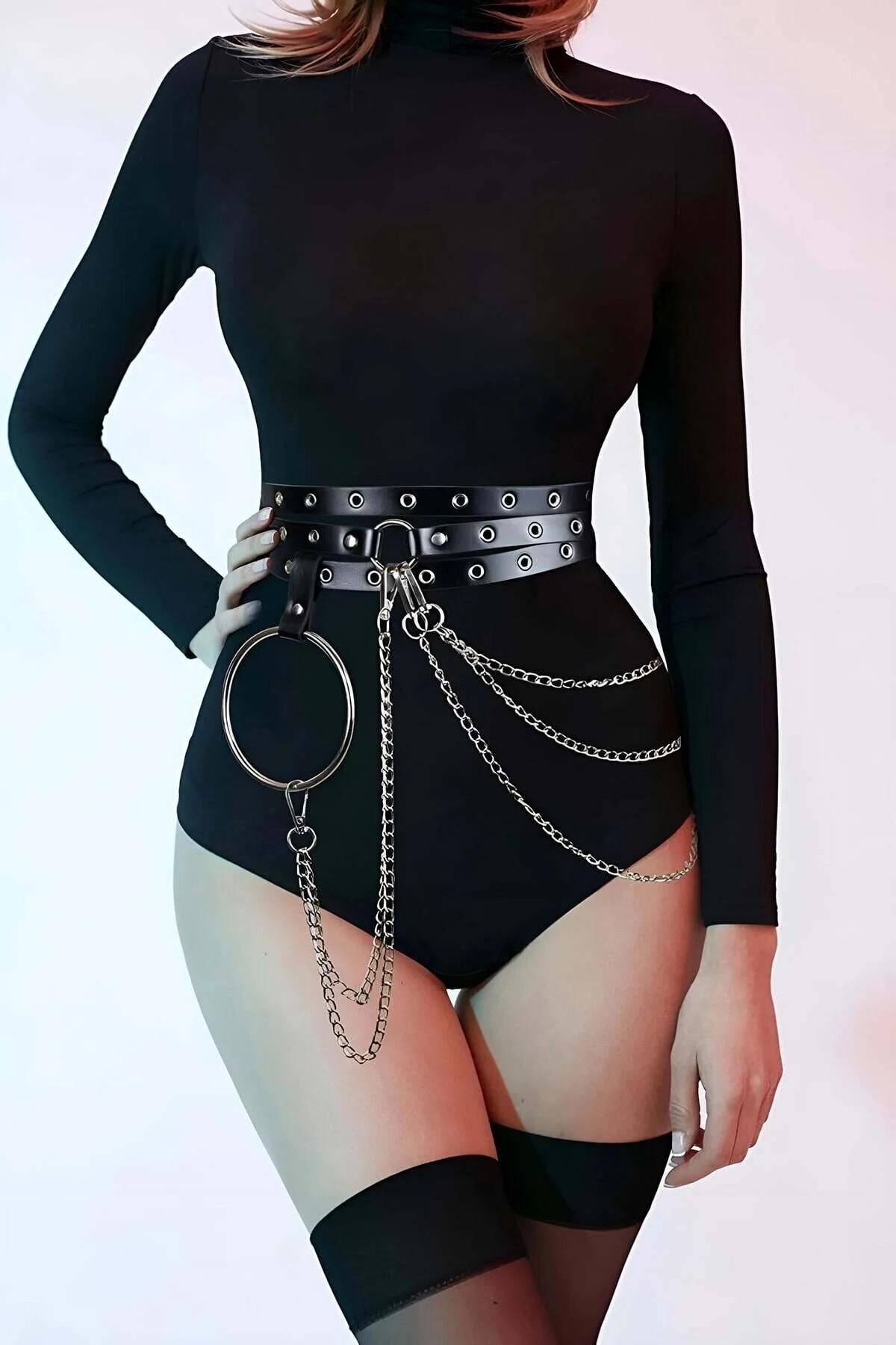 Black faux leather waist harness belt with silver eyelet grommets, large O-ring pendant, and cascading multi-chain drape at h