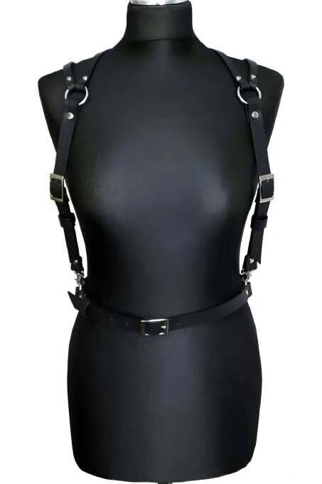 Black faux leather shoulder and chest harness with silver O-rings, rectangular buckles, and waist belt on mannequin