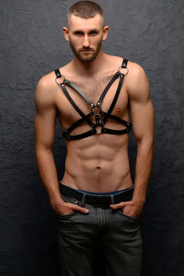 black faux leather chest harness with silver O-rings multi-strap front panel worn by man