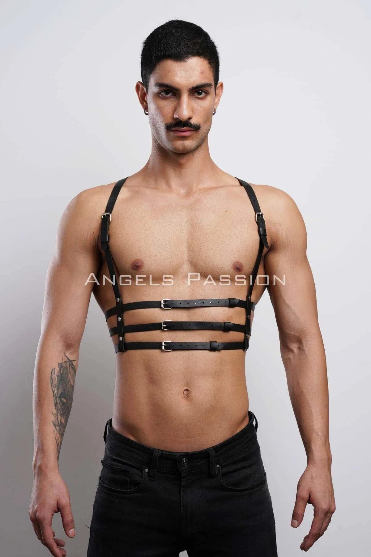 Black faux leather strappy chest harness with three silver-tone rectangular buckles worn by male model