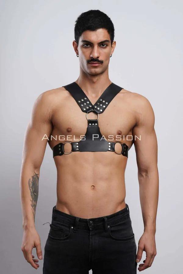 black faux leather chest harness with silver dome studs and three O-rings on male torso