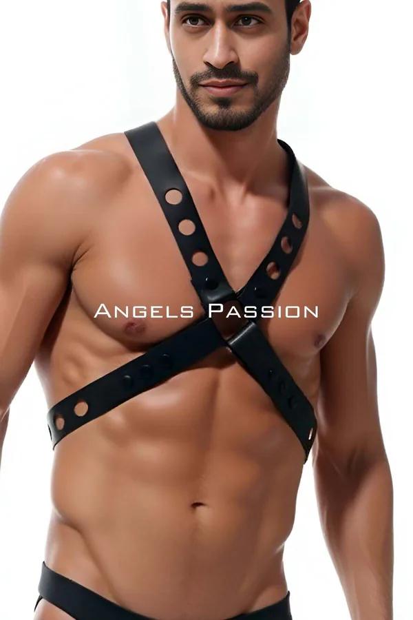 black faux leather X-strap mens harness with circular eyelet cutouts and silver center buckle worn on bare chest
