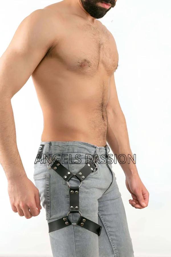 black faux leather leg harness with silver O-rings worn over light-wash jeans, narrow 1.5 cm straps at hip and upper thigh