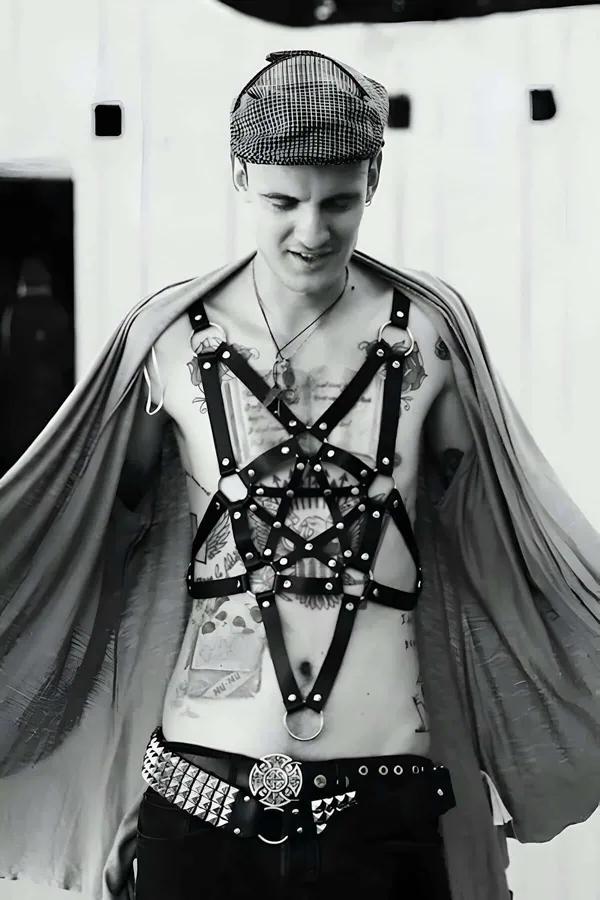 black faux leather star cage body harness with silver O-rings and rivets worn on male chest