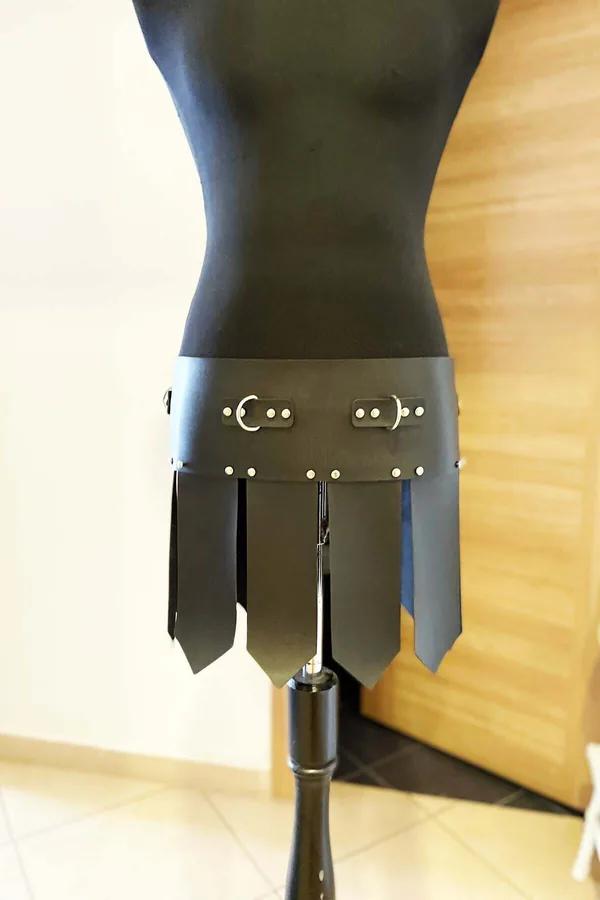 Black faux leather gladiator waist belt with seven pointed panel skirt strips and silver D-ring buckles on dress form