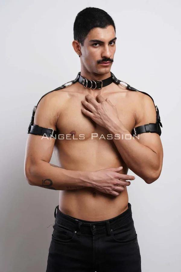 Black faux leather choker and shoulder harness with silver O-ring accents worn by male model