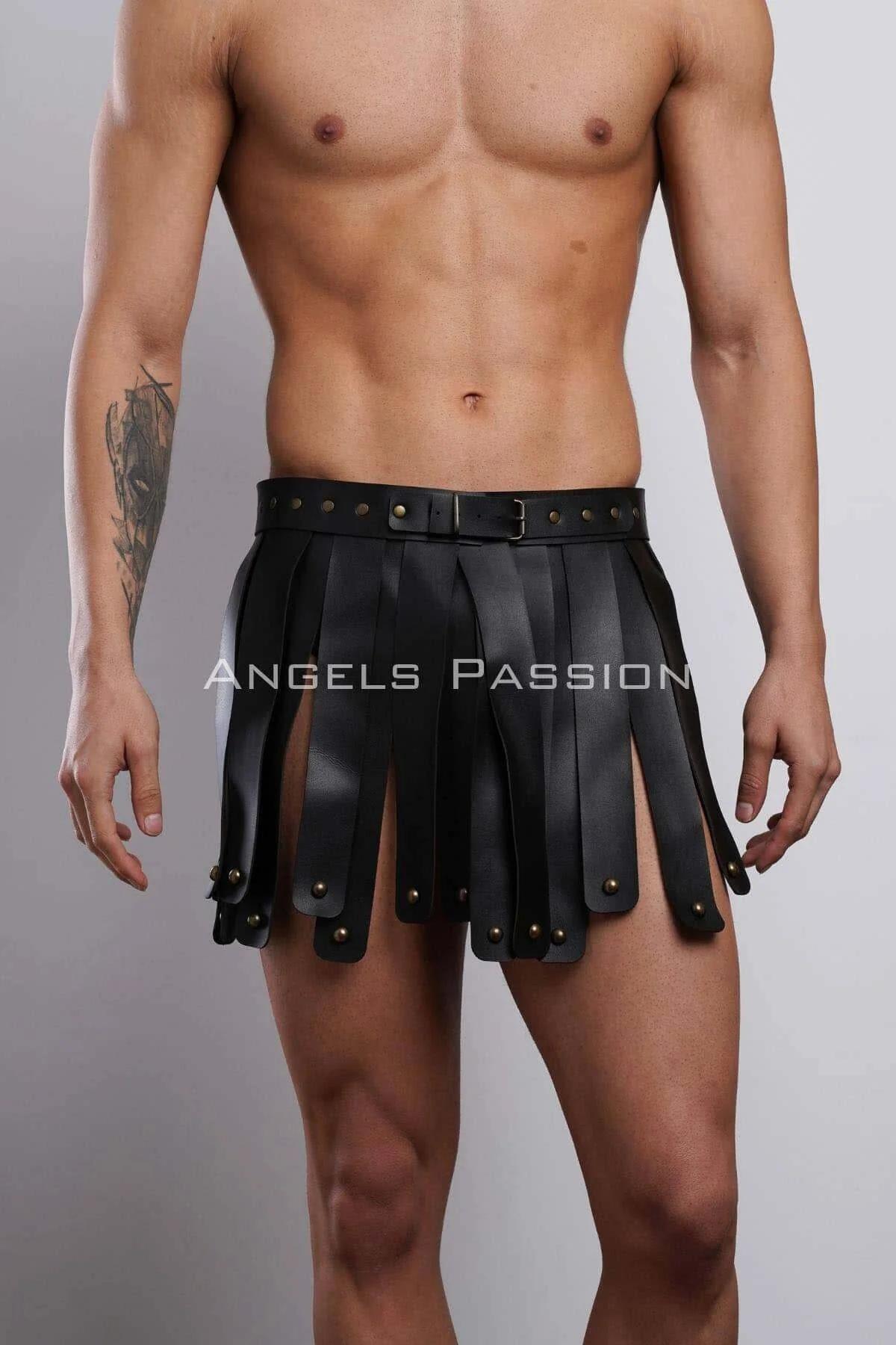 Black faux leather gladiator kilt harness with brass stud-tipped vertical panels and wide adjustable waistband buckle on male